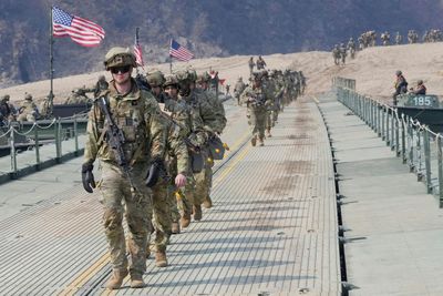 Israel vs US Military Comparison 2026 Ã¢â‚¬â€ US soldiers crossing a tactical bridge during joint military operations