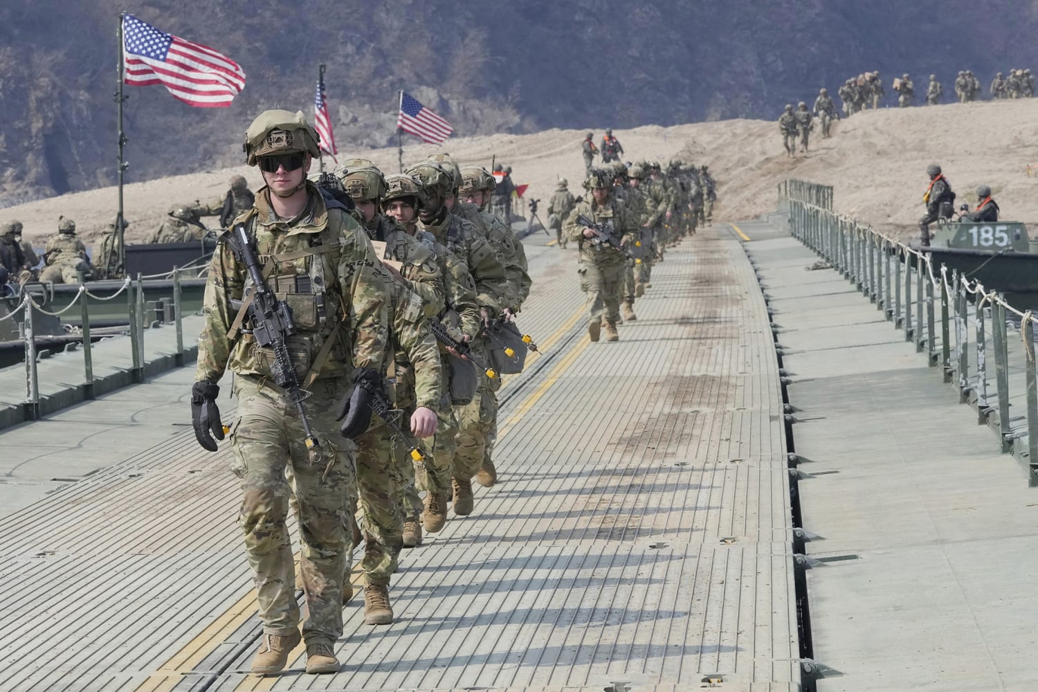 Israel vs US Military Comparison 2026 — US soldiers crossing a tactical bridge during joint military operations